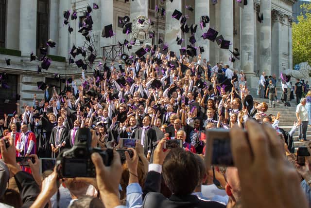 Graduates throw their mortar boards in the air during a University of Portsmouth graduation ceremony at The Guildhall, Portsmouth. Photo: Melanie Leininger (142225-18)
