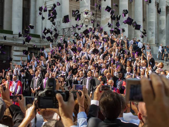Graduates throw their mortar boards in the air during a University of Portsmouth graduation ceremony at The Guildhall, Portsmouth. Photo: Melanie Leininger (142225-18)