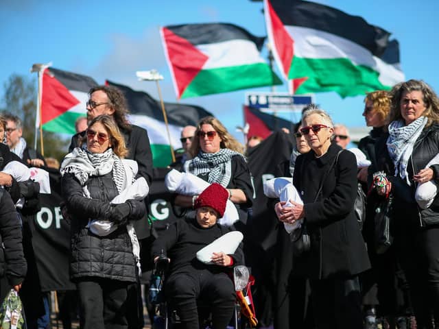 Women hold packages symbolising dead children.Picture: Chris Moorhouse (jpns 170324-23)