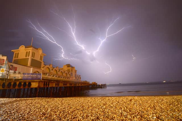 Lightning striking behind South Parade Pier. Picture: Tony Wallace