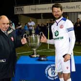 Gosport Borough captain for the night Dan Wooden, right, picks up the Portsmouth Senior Cup trophy Picture: Neil Marshall