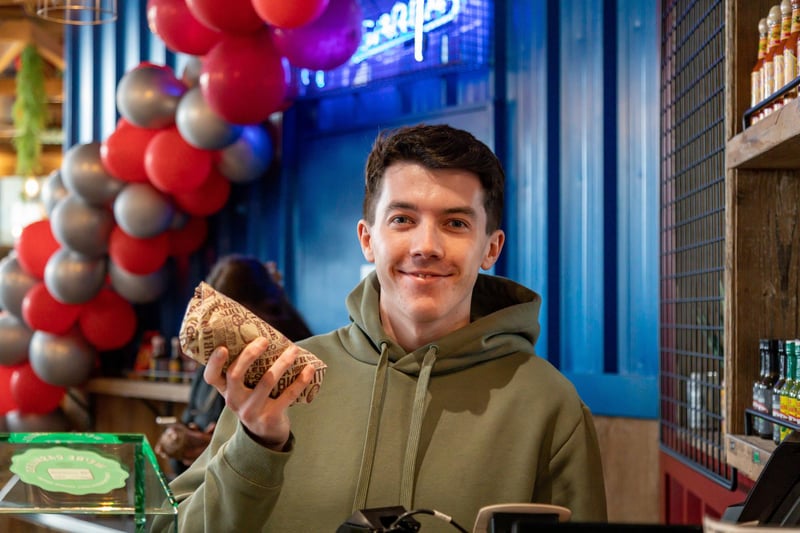 A satisfied customer at the big burrito giveaway at Tortilla, Gunwharf Quays.Picture: Mike Cooter