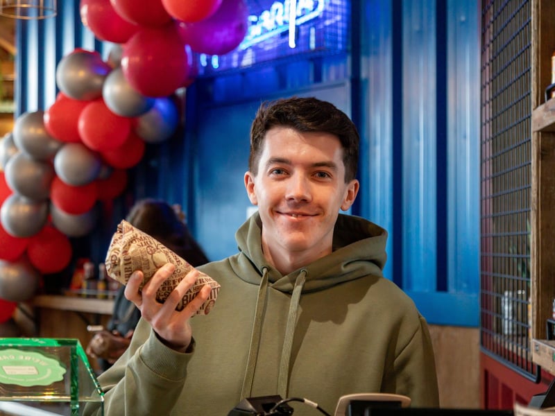 A satisfied customer at the big burrito giveaway at Tortilla, Gunwharf Quays.Picture: Mike Cooter