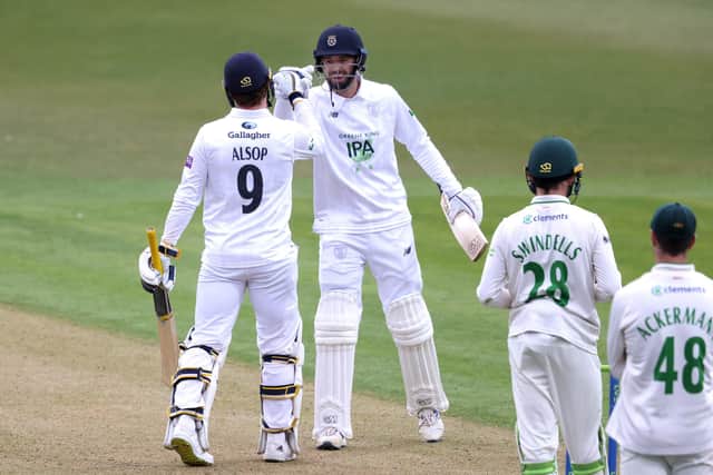 Tom Alsop is congratulated by James Vince after reaching is third first class century. Photo by Alex Pantling/Getty Images.