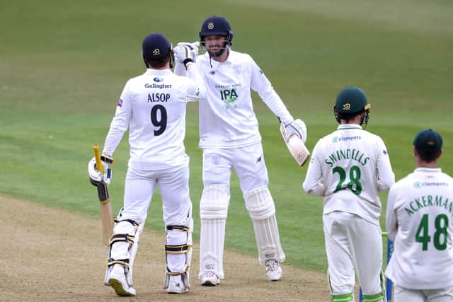 Tom Alsop  is congratulated by James Vince after reaching is third first class century. Photo by Alex Pantling/Getty Images.
