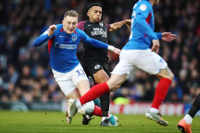 Pompey's Ronan Curtis in action against former team-mate and Peterborough defender Nathan Thompson last season. Picture: Joe Pepler