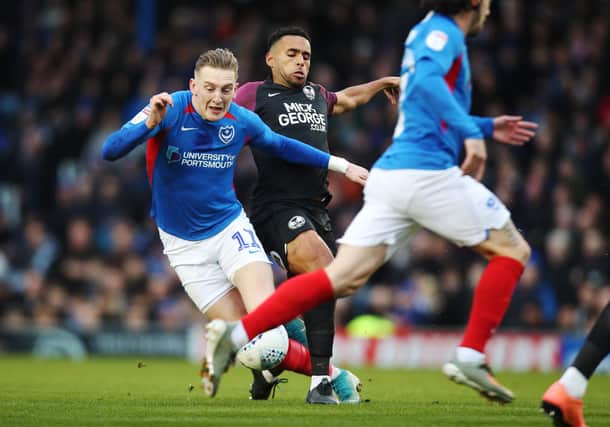 Pompey's Ronan Curtis in action against former team-mate and Peterborough defender Nathan Thompson last season. Picture: Joe Pepler