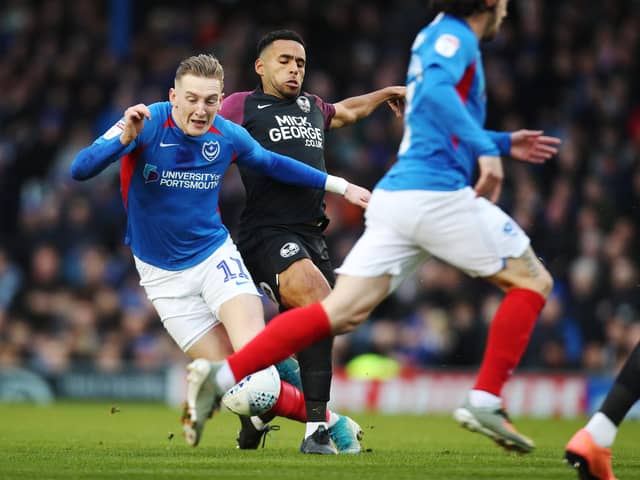 Pompey's Ronan Curtis in action against former team-mate and Peterborough defender Nathan Thompson last season. Picture: Joe Pepler