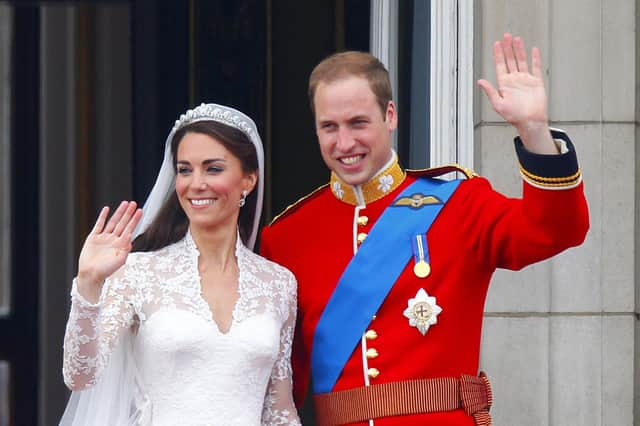 Prince William and his wife Kate Middleton, wave to the crowds from the balcony of Buckingham Palace, London, following their wedding at Westminster Abbey on April 29, 2011. Photo credit should read: Chris Ison/PA Wire