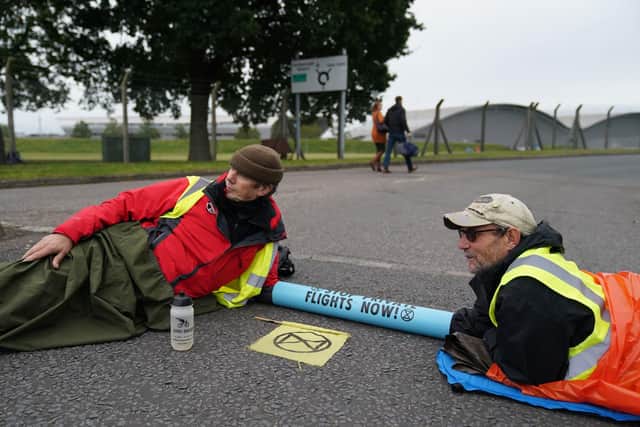Extinction Rebellion activists protest outside Farnborough Airport in Hampshire in protest against emissions from private jets. Picture date: Saturday October 2, 2021. PA Photo. See PA story ENVIRONMENT Airport. Photo credit should read: Andrew Matthews/PA Wire