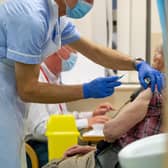 A patient receiving a vaccination at Fareham Community Hospital. New tiers come into force today because of a coronavirus variant that spreads more quickly 
Picture: Habibur Rahman