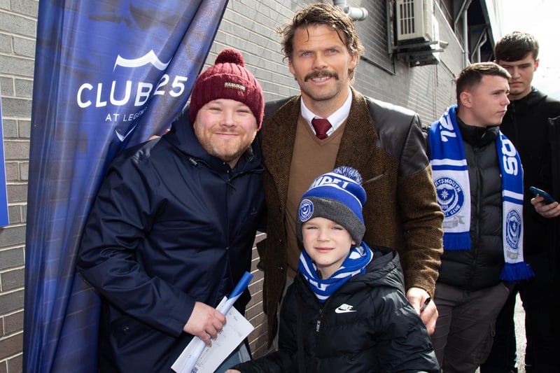 The Hermannator, Hermann Hreidarsson, poses with fans ahead of the game.