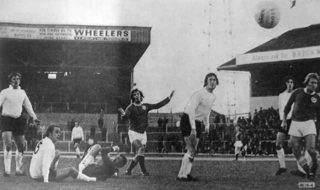 Norman Piper, centre, shoots narrowly over against Luton at Fratton Park