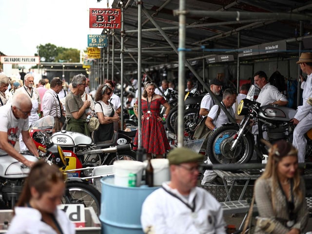 Mechanics prepare classic motorbikes to race during the opening day of Goodwood Revival at the Goodwood Motor Circuit in Chichester on September 8, 2023. The only historic motor race meeting to be staged entirely in a period theme, Goodwood Revival is an immersive celebration of iconic cars and fashion. (Photo by HENRY NICHOLLS / AFP) (Photo by HENRY NICHOLLS/AFP via Getty Images)