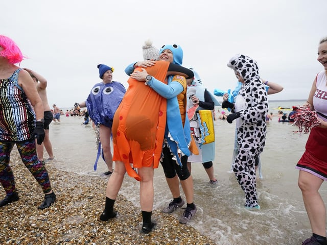 People take part in the Gosport New Year's Day Dip in The Solent at Stokes Bay, Gosport, Hampshire, to raise money for Gosport and Fareham Inshore Rescue Service.