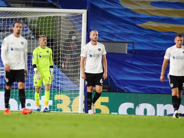 Pompey's Jack Whatmough and Portsmouth's Craig MacGillivray are dejected after another Brighton goal in the 4-0 Carabao Cup defeat. Picture: Joe Pepler