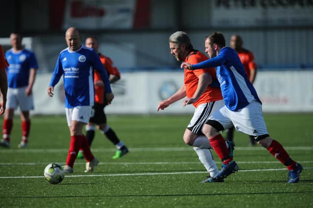 AFC Portchester Vets (orange) v Team Figgins. Picture: Chris Moorhouse