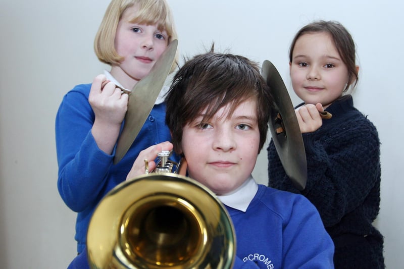 Abercrombie primary pupils Mia Cooper, Euan Bagshaw and Alesha White get ready for their orchestra lesson.