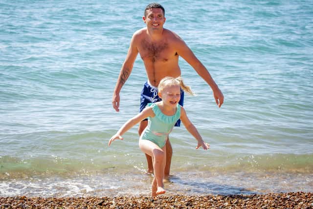Bow 4 and her step dad, Ryan Elly having fun in the water at the Hot Walls in Old Portsmouth. Picture: Habibur Rahman