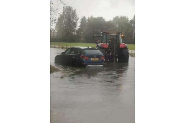 Hayling Island teen, Darcy Atkins, helps rescue a car stranded in flood water.