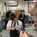 Trent Blake, 13, putting together his protective face shield.
