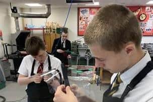 Trent Blake, 13, putting together his protective face shield.