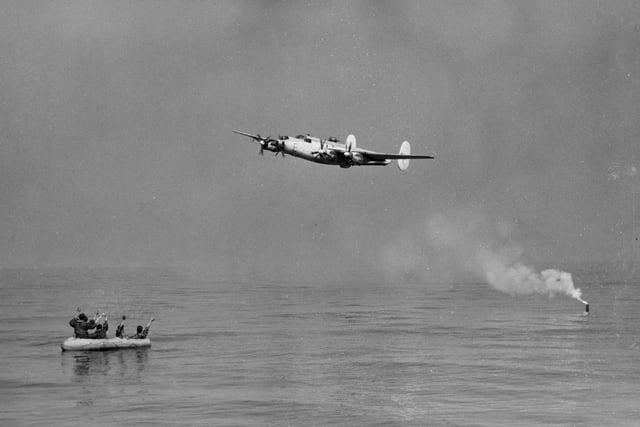 30th August 1955:  An Avro Shackleton aircraft drops a flare over a distressed dinghy to mark its location for a rescue helicopter during a demonstration by the RAF Search and Rescue 22 Helicopter Squadron off Portsmouth. Various types of rescue were demonstrated including use of radio beacons.  (Photo by L. Blandford/Topical Press Agency/Getty Images)
