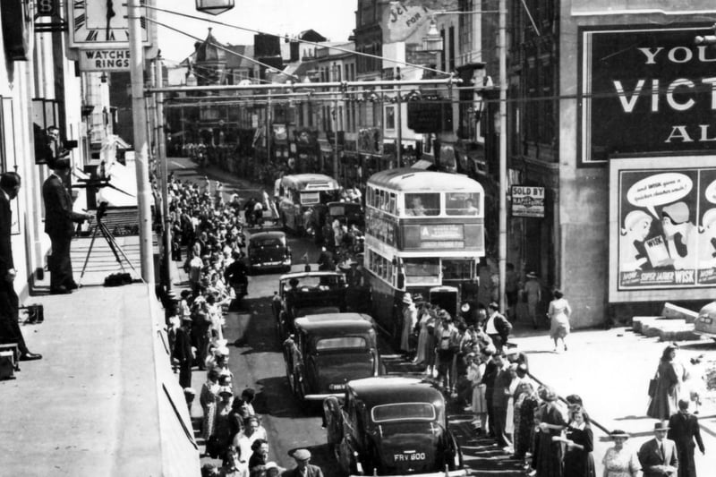 Princess Elizabeth's motorcade heading north along Commercial Road in 1951. Notice the photographers on the ledge to the left.