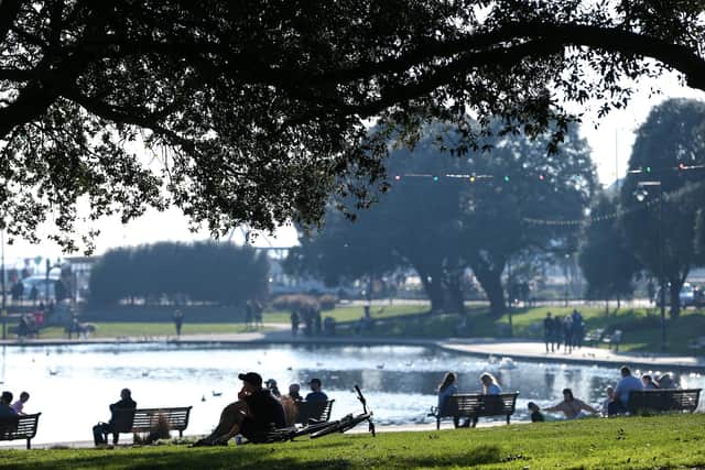People relaxing at Canoe Lake, Southsea, on Saturday afternoon. Picture: Chris Moorhouse (270221-29)