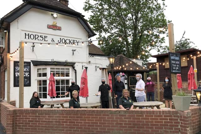 Key workers practice social distancing while picking up their free meal from the Horse and Jockey, in Curbridge. Picture: Sean Woodward.
