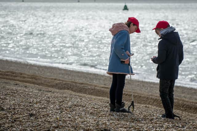 Chernobyl children are litter picking on Southsea beach opposite Clarence Pier on 17 March 2020.
Pictured: Ivanna 11 and Serhiy 11 picking up litter.
Picture: Habibur Rahman