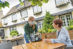 Greene King staff in PPE at a pub. Picture: Adam Smyth/Greene King /PA Wire