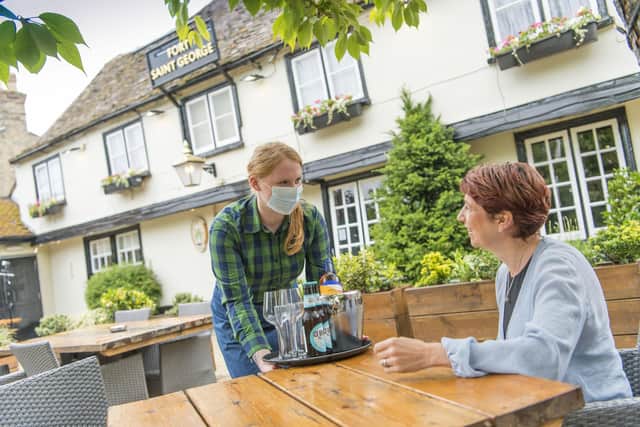 Greene King staff in PPE at a pub. Picture: Adam Smyth/Greene King /PA Wire