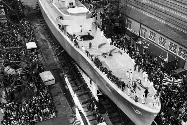 Hundreds of spectators watch the launch of HMS Andromeda in Portsmouth Dockyard in May 1967