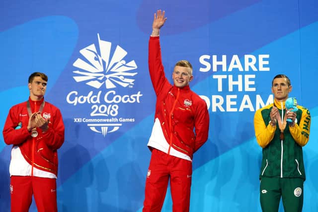 Adam Peaty (centre) after winning the 100m breaststroke final at the Commonwealth Games in Gold Coast. Fellow England swimmer James Wilby is pictured left and South African Cameron van der Burgh (bronze) is on the right. Photo by Clive Rose/Getty Images.