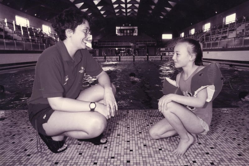 Life Guard Pam Miles (23) talks to Carla Padmore (9) at Victoria Swimming Baths, Portsmouth, 1995. The News PP5374