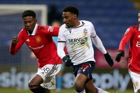 Di'Shon Bernard (left) on the comeback trail following injury for Manchester United Under-21s against Bolton in the Papa John's Trophy in November 2022. Picture: Matthew Peters/Manchester United via Getty Images