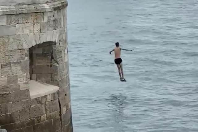 A youth is seen leaping from Old Portsmouth's Hot Walls. Photo: Twitter/Proud of Portsmouth