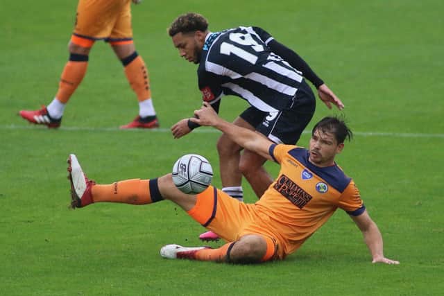 Craig Robson slides in to make a challenge during Hawks' FA Cup win at Bath City. Picture: Kieron Louloudis