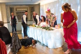 The top table rushes to help the singing waiter. Picture: Carla Mortimer Photography