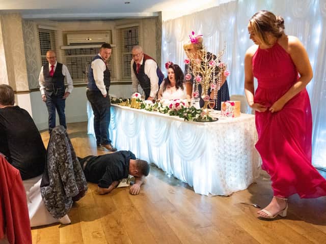 The top table rushes to help the singing waiter. Picture: Carla Mortimer Photography