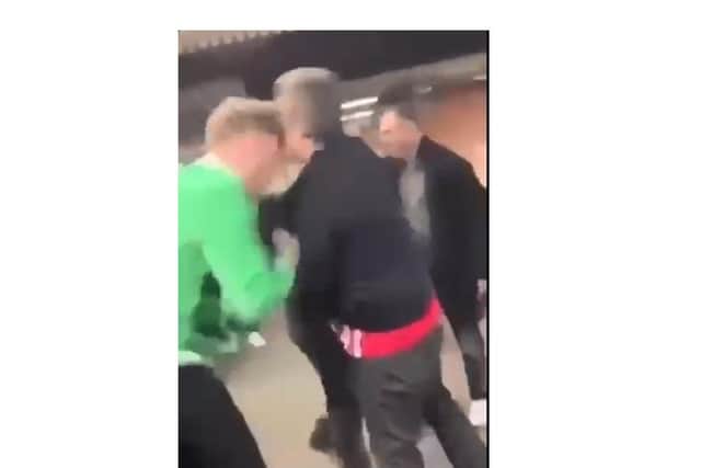 Police are hunting for the man in the green, left, after headbutting the Southampton fan, right.