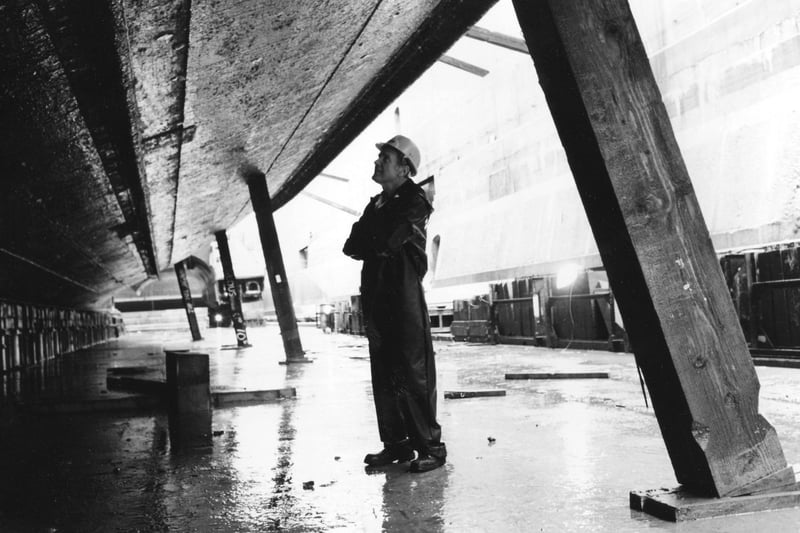 Shipwright Peter Collings takes a look at the bilge keel of HMS Warrior in January 1994. The News PP4339