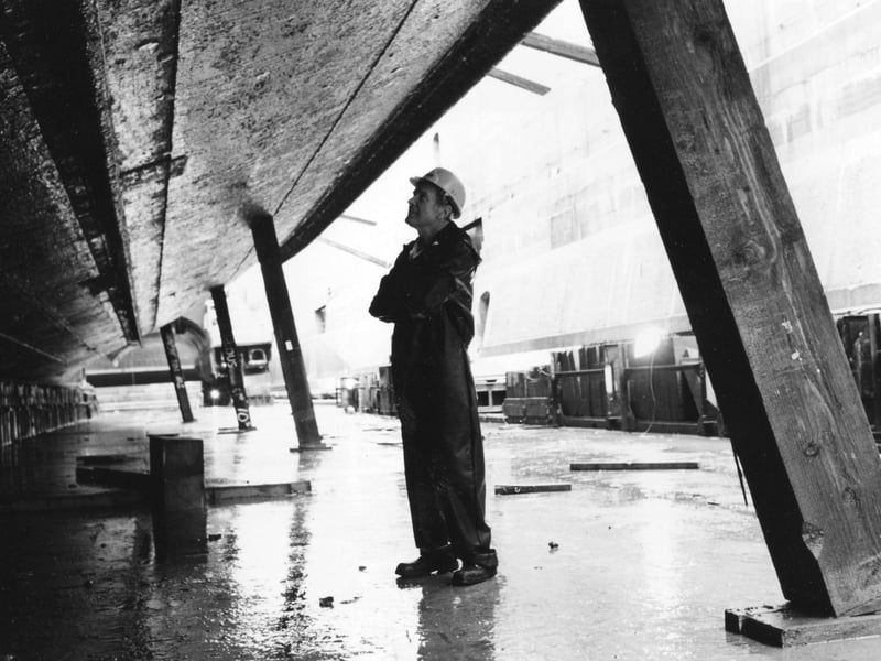 Shipwright Peter Collings takes a look at the bilge keel of HMS Warrior in January 1994. The News PP4339