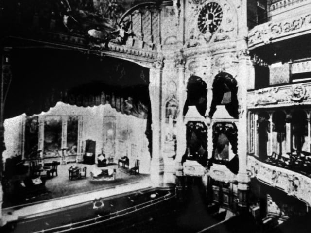 An early photograph, soon after its enlargement in 1900, showing the theatre in its full beauty. The division between the orchestra stalls and the pit can be seen. The fine conductors stand and orchestra pit rail have alas disappeared.