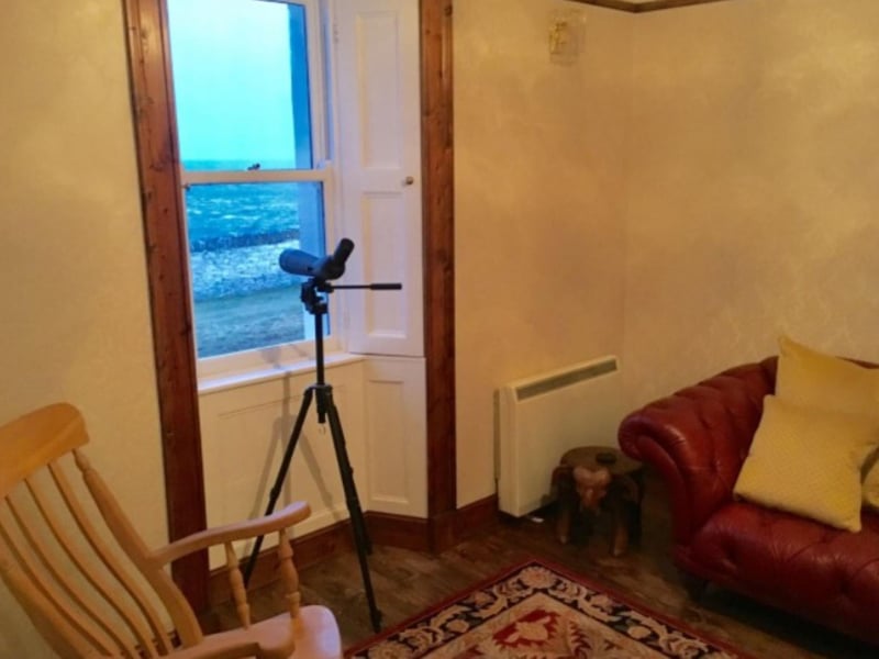 There's a telescope at the window to keep an eye out for wildlife in the waters below.