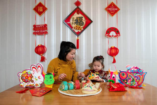 Yang Lu with her daughter Eliza Varga (2) and the traditional lion steamed buns she has made for Chinese New Year. © Jordan Pettitt/Solent News & Photo Agency