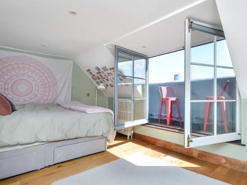 The listing says: "On the first floor is a substantial 16' bedroom, feature bathroom and fourth bedroom with two further bedrooms, one having a ladder style staircase leading to a sleeping area and shower room on the top floor, off the second bedroom is a narrow balcony ideal for the morning coffee as it faces in an easterly direction."