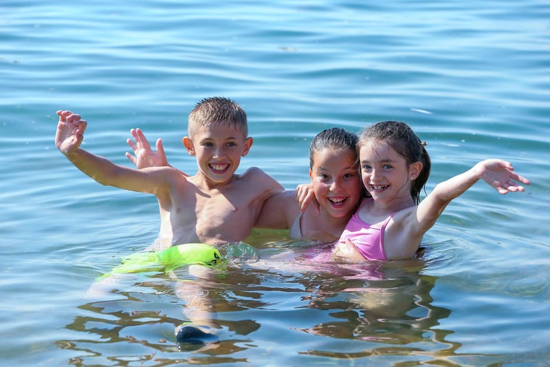 From left, Logan, 10, Yazmin, 12, and Ellie, 7, in the water off the Hotwalls, Old Portsmouth