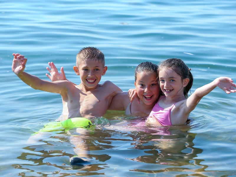 From left, Logan, 10, Yazmin, 12, and Ellie, 7, in the water off the Hotwalls, Old Portsmouth